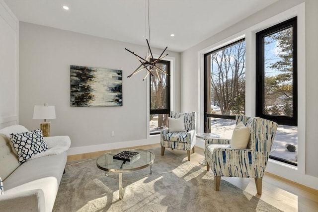 sitting room featuring plenty of natural light and light hardwood / wood-style flooring