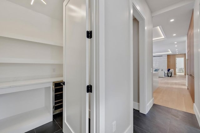 corridor featuring dark tile patterned floors