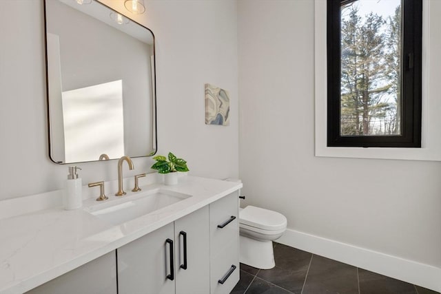 bathroom with vanity, tile patterned floors, and toilet