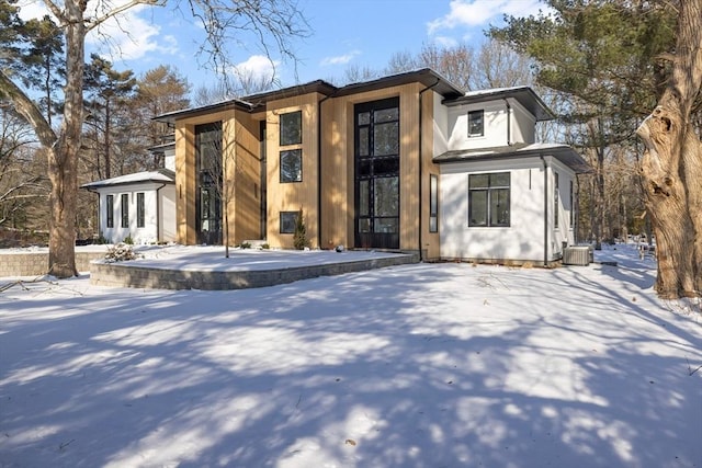 contemporary house featuring central AC unit