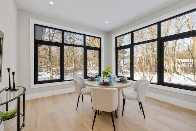 dining room with plenty of natural light and light hardwood / wood-style flooring