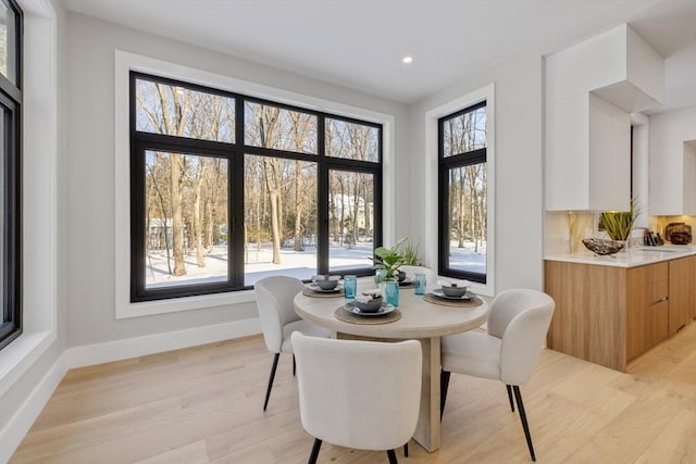 dining room with sink and light hardwood / wood-style floors