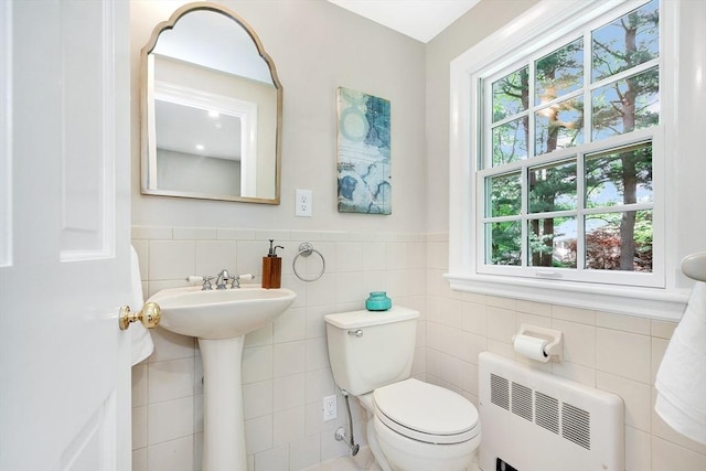 27 Lantern Ln, Arlington, MA 02474 - bathroom with plenty of natural light, toilet, tile walls, a wainscoted wall, and a sink