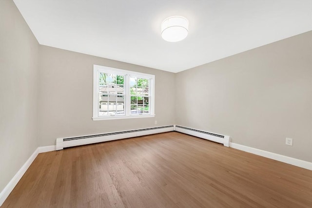 27 Lantern Ln, Arlington, MA 02474 - empty room featuring a baseboard heating unit, wood finished floors, and baseboards
