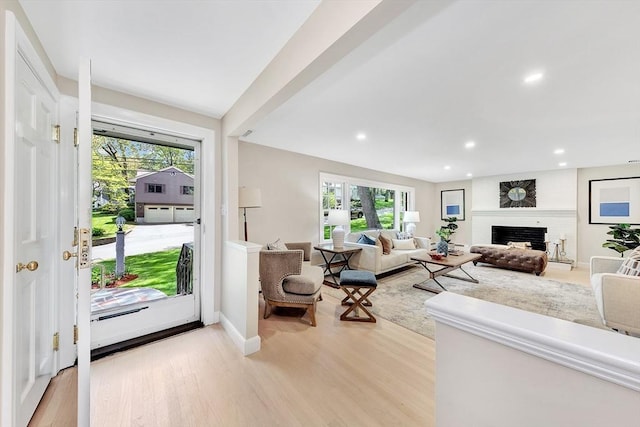 27 Lantern Ln, Arlington, MA 02474 - living room with healthy amount of natural light, light wood finished floors, recessed lighting, a brick fireplace, and baseboards