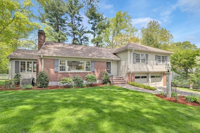 27 Lantern Ln, Arlington, MA 02474 - tri-level home featuring brick siding, an attached garage, a chimney, and a front yard