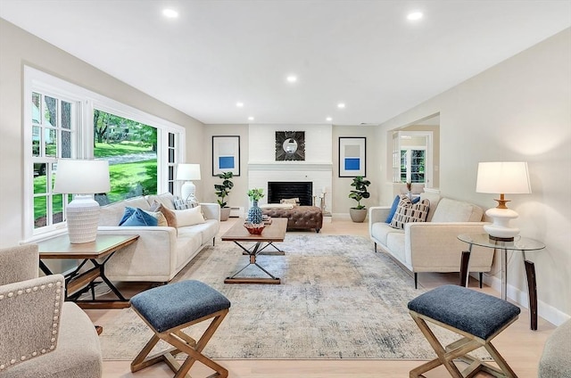 27 Lantern Ln, Arlington, MA 02474 - living room featuring recessed lighting, light wood-style floors, a large fireplace, baseboards, and baseboard heating