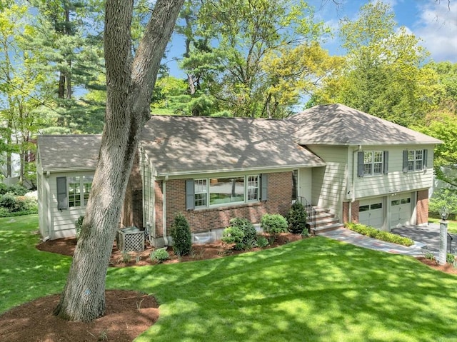 27 Lantern Ln, Arlington, MA 02474 - tri-level home with brick siding, a front lawn, a shingled roof, concrete driveway, and an attached garage