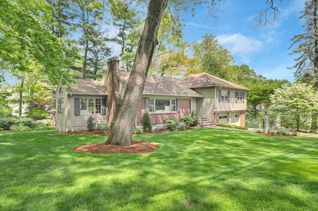 27 Lantern Ln, Arlington, MA 02474 - view of front of property with a chimney, an attached garage, a front yard, and brick siding
