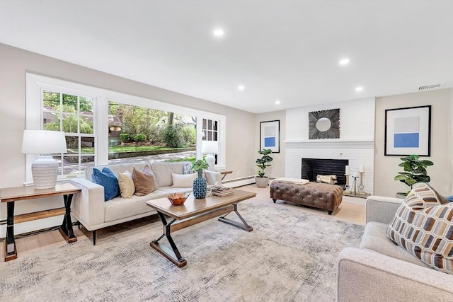 27 Lantern Ln, Arlington, MA 02474 - living room with healthy amount of natural light, recessed lighting, a brick fireplace, light wood-style floors, and baseboard heating