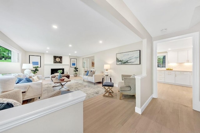 27 Lantern Ln, Arlington, MA 02474 - living room with light wood-type flooring, a fireplace, recessed lighting, and baseboards