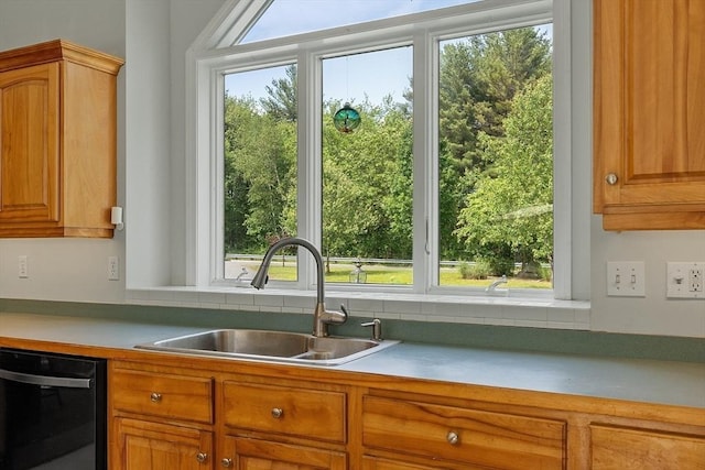 7 Humiston Cir, Westford, MA 01886 - kitchen with dishwashing machine, a sink, brown cabinetry, and light countertops