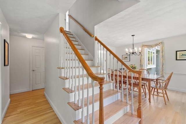 7 Humiston Cir, Westford, MA 01886 - staircase with wood finished floors, a chandelier, and baseboards