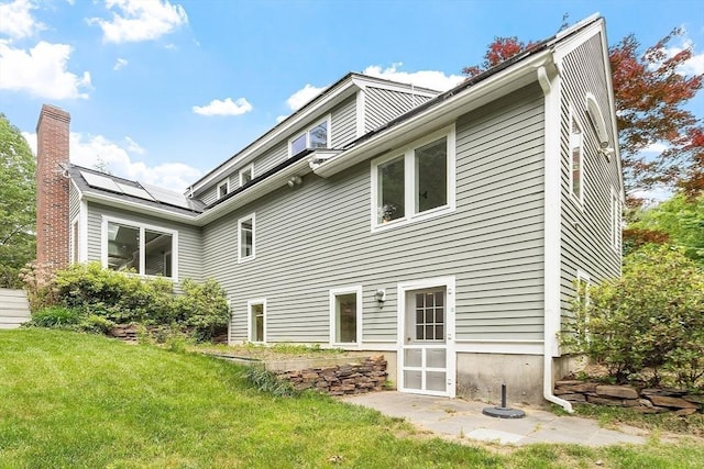 7 Humiston Cir, Westford, MA 01886 - rear view of property with a yard, a chimney, and solar panels