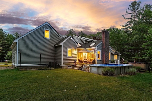 7 Humiston Cir, Westford, MA 01886 - rear view of property featuring a chimney, a wooden deck, an outdoor pool, and a lawn