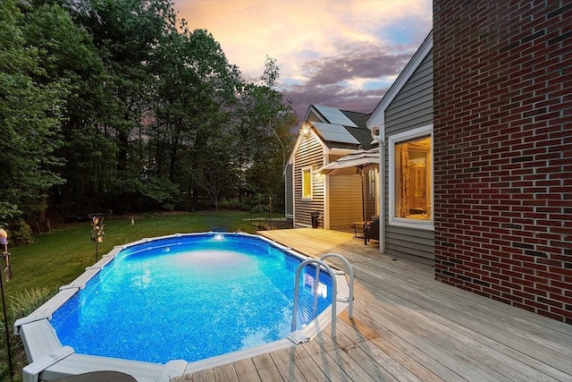 7 Humiston Cir, Westford, MA 01886 - pool at dusk featuring a deck, a lawn, and an outdoor pool