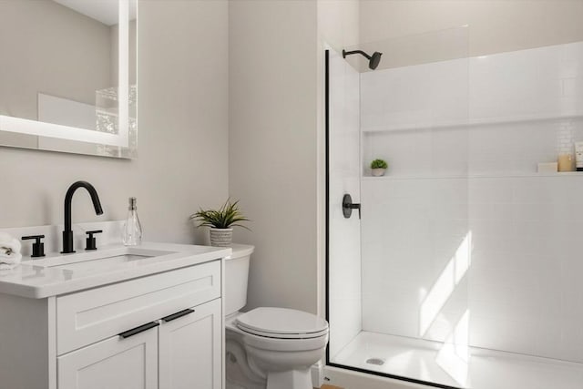 1 Cross St Unit 205, Wilmington, MA 01887 - bathroom featuring vanity, tiled shower, and toilet