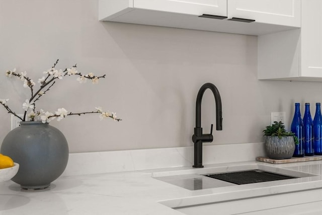 1 Cross St Unit 205, Wilmington, MA 01887 - kitchen view of a sink, white cabinetry, and light countertops