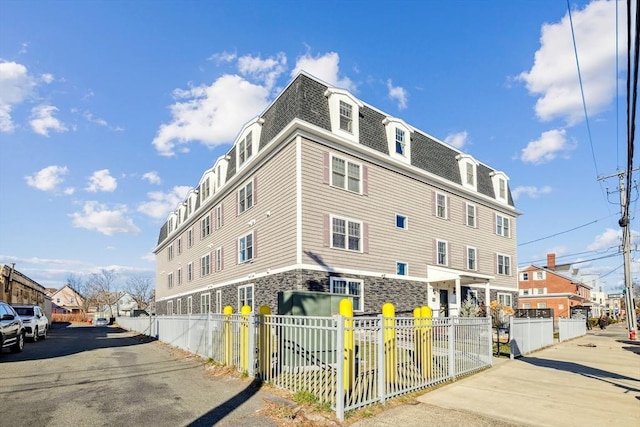 view of building exterior with a fenced front yard