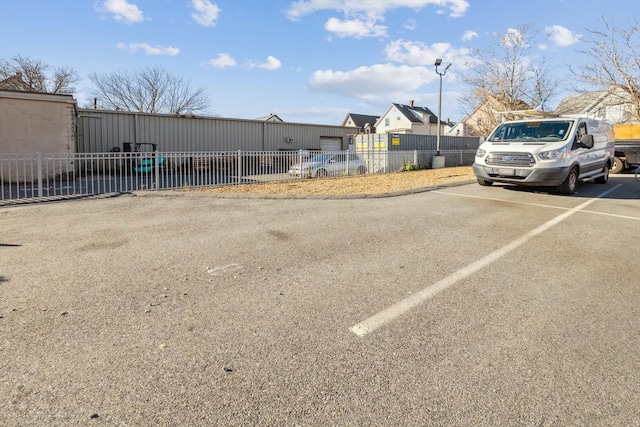 view of car parking featuring fence