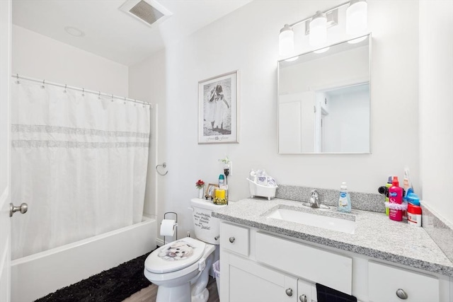 bathroom featuring visible vents, toilet, vanity, and shower / bath combo