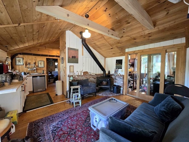 60 Camp Rd, Leverett, MA 01054 - living room with vaulted ceiling with beams, a wood stove, wood ceiling, and hardwood / wood-style flooring