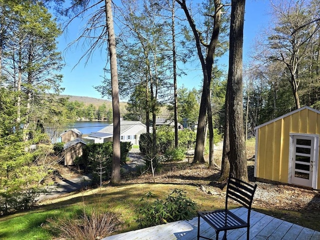 60 Camp Rd, Leverett, MA 01054 - view of yard featuring a deck with water view, a storage unit, and an outdoor structure
