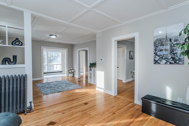 foyer with wood-type flooring, radiator, and coffered ceiling