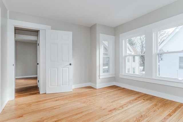 unfurnished bedroom with a closet and light hardwood / wood-style flooring