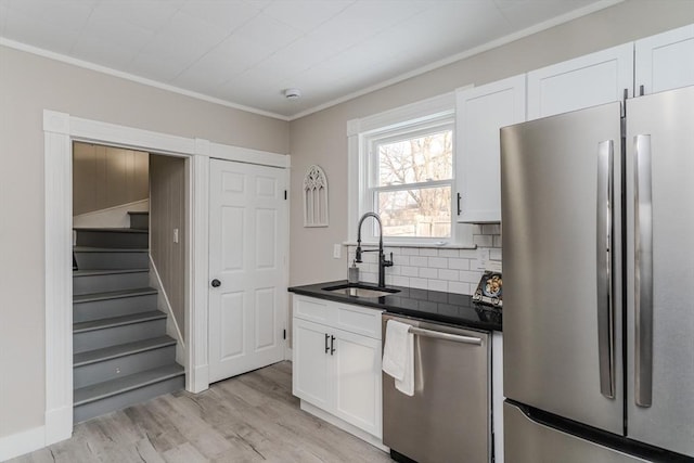 kitchen featuring white cabinets, light hardwood / wood-style floors, sink, and stainless steel appliances