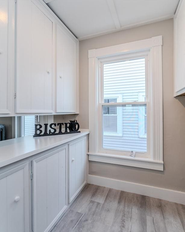 kitchen with white cabinets and light hardwood / wood-style floors