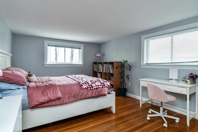 bedroom featuring baseboards and wood finished floors