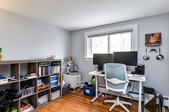 office featuring baseboard heating and wood finished floors
