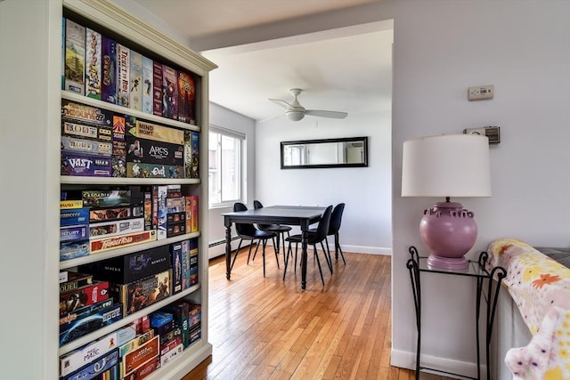 dining space with wood-type flooring, baseboards, and ceiling fan