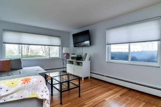 bedroom featuring baseboard heating and light wood-style flooring
