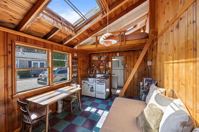 interior space with dark floors, wood walls, wooden ceiling, and vaulted ceiling with skylight