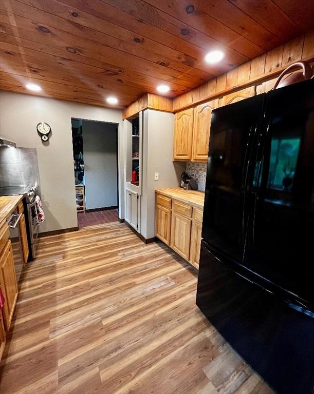 1472 Pleasant St, Athol, MA 01331 - kitchen featuring freestanding refrigerator, wood ceiling, light wood-style flooring, light brown cabinetry, and backsplash