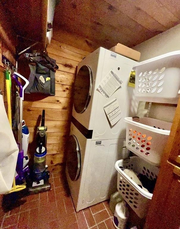 1472 Pleasant St, Athol, MA 01331 - laundry room featuring stacked washer / drying machine and wooden walls