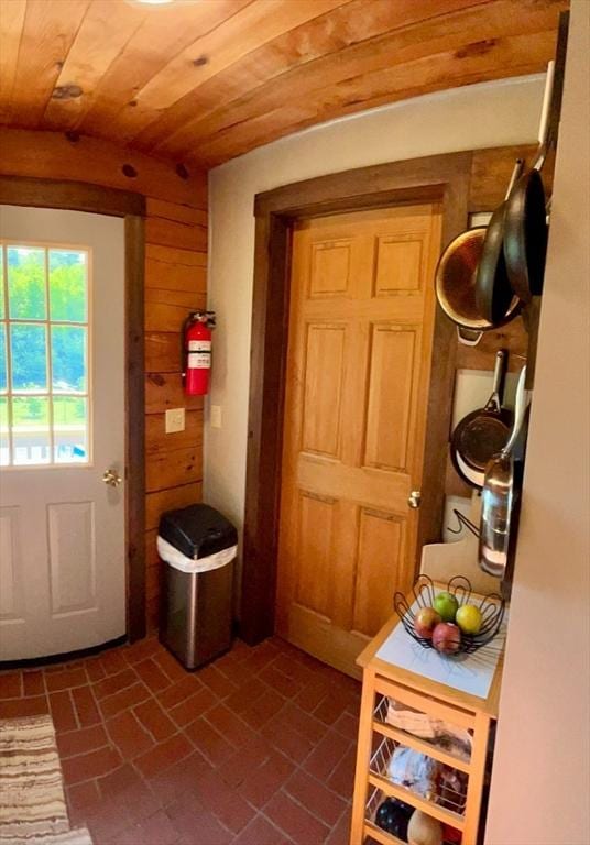 1472 Pleasant St, Athol, MA 01331 - doorway featuring brick patterned floors, wood ceiling, and wooden walls