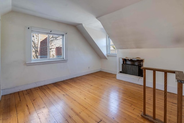 bonus room featuring lofted ceiling and light hardwood / wood-style flooring