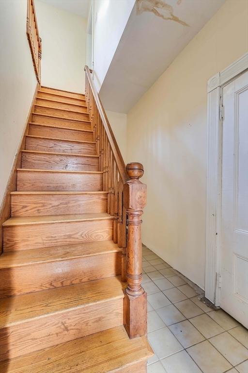 staircase featuring tile patterned flooring