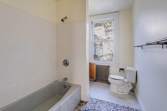 bathroom with tiled shower / bath, radiator heating unit, tile patterned floors, and toilet