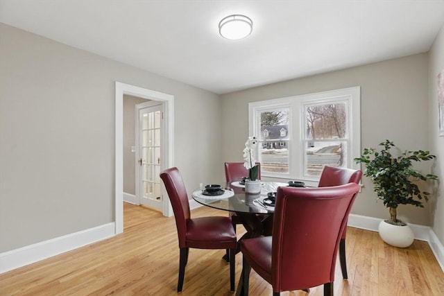 dining room featuring baseboards and wood finished floors