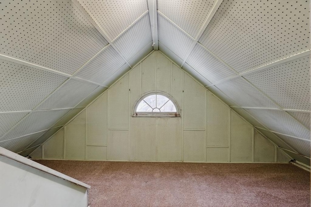 bonus room with carpet and vaulted ceiling