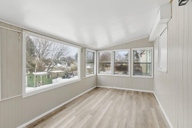 unfurnished sunroom featuring vaulted ceiling