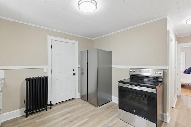 kitchen featuring baseboards, ornamental molding, appliances with stainless steel finishes, light wood-type flooring, and radiator heating unit