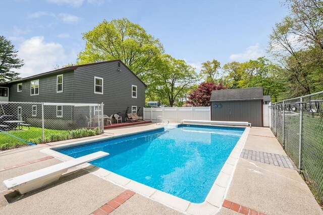 4 Pleasantview Ave, Tyngsborough, MA 01879 - view of pool featuring a fenced backyard, a diving board, a storage shed, and an outdoor structure