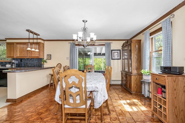 4 Pleasantview Ave, Tyngsborough, MA 01879 - dining space featuring a chandelier, baseboard heating, crown molding, and baseboards