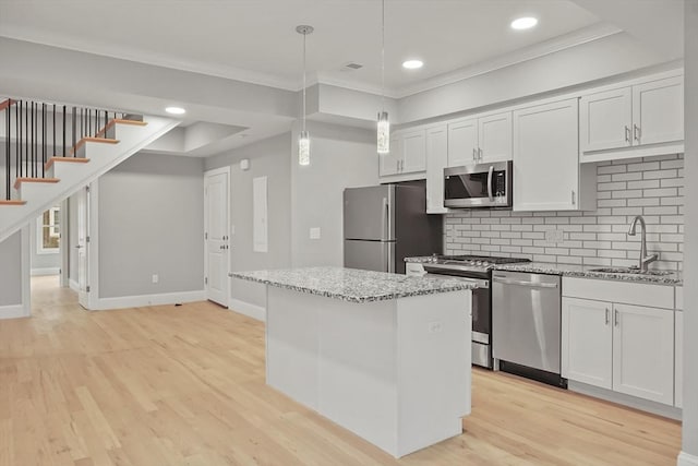 7 Waumbeck St Unit 3, Boston, MA 02121 - kitchen featuring a sink, ornamental molding, stainless steel appliances, and decorative backsplash