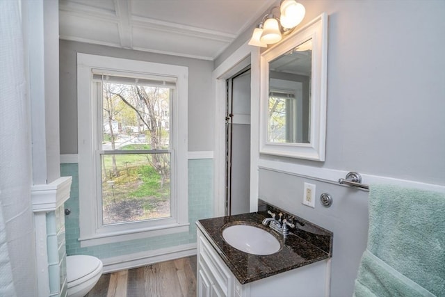 bathroom with crown molding, beamed ceiling, toilet, wood finished floors, and vanity